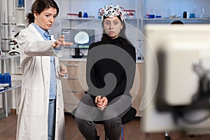 Doctor researcher EEG headset analyzing patient& x27;s evolution