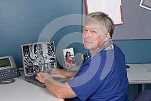 Doctor reviewing MRI on laptop