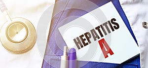 Doctor robe, stethoscope, pens and note with text hepatitis a