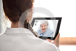DoctorÃÂ´s consultation with telemedicine or telehealth, elderly photo