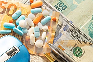 Doctor`s desk with money and medicines. Concept of health cost