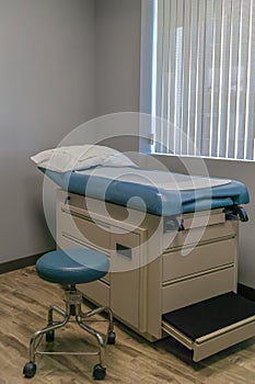 Doctor`s Exam Room with table and stool with no people