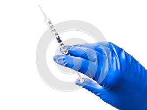 Doctor`s hand in blue medical glove holding open syringe with medical solution isolated white background. Flu vaccine