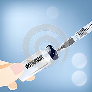 The doctor`s hand fills the syringe with vaccine from the bottle close-up for injection on blue background. Illustration of COVID