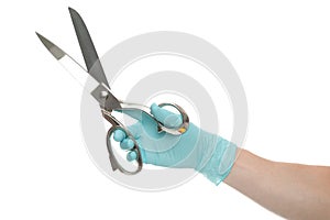 Doctor`s hand in glove holding a silver scissor isolated over white background