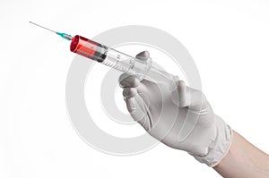 Doctor's hand holding a syringe, white gloved hand, a large syringe, the doctor makes an injection, white background
