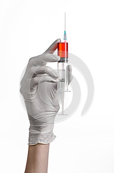 Doctor's hand holding a syringe, white gloved hand, a large syringe, the doctor makes an injection, white background