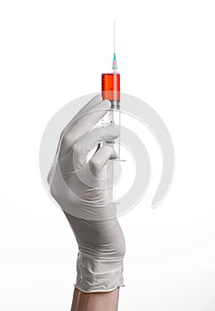 Doctor's hand holding a syringe, white gloved hand, a large syringe, the doctor makes an injection, white background