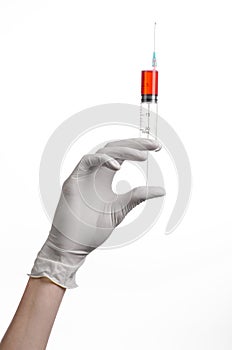 Doctor's hand holding a syringe, white gloved hand, a large syringe, the doctor makes an injection, white background