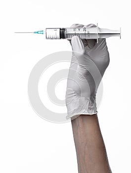 Doctor's hand holding a syringe, white-gloved hand, a large syringe, medical issue, the doctor makes an injection
