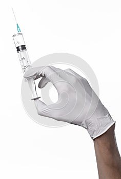 Doctor's hand holding a syringe, white-gloved hand, a large syringe, medical issue, the doctor makes an injection