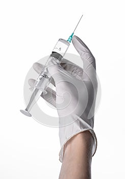 Doctor's hand holding a syringe, white-gloved hand, a large syringe, medical issue, the doctor makes an injection
