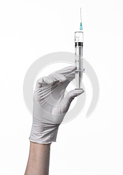 Doctor's hand holding a syringe, white-gloved hand, a large syringe, medical issue, the doctor makes an injection