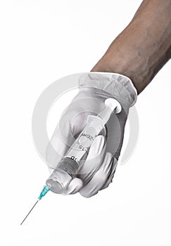 Doctor's hand holding a syringe, white-gloved hand, a large syringe, medical issue, the doctor makes an injection