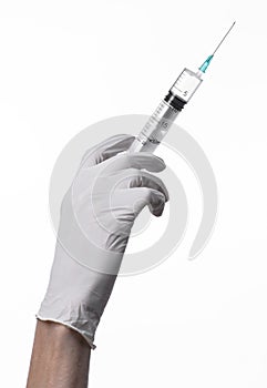 Doctor's hand holding a syringe, white-gloved hand, a large syringe, medical issue, the doctor makes an injection