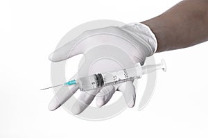 Doctor's hand holding a syringe, white-gloved hand, a large syringe, medical issue, the doctor makes an injection