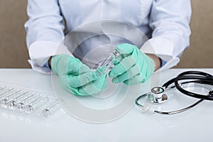 Doctor`s hand holds a vial with the medicine