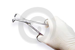 Doctor`s hand in the medical latex glove holding Medical umbilical cord scissor