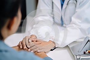 Doctor's hand reassuring elderly patient