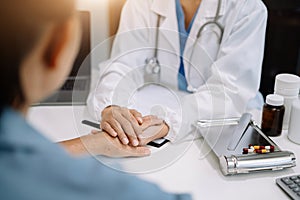 Doctor's hand reassuring elderly patient