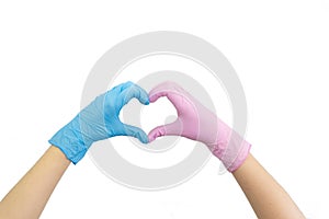 Doctor`s hands in blue and pink gloves making heart shape isolated on white. Woman`s hand gesture or sign. Virus