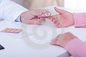 Doctor's hands giving patient medicament photo