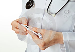 Doctor's hands holding thermometer