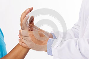 The doctor`s hands are massage the patient`s hand due to injury.