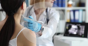 Doctor's hands with a probe on a woman's neck