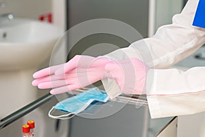 Doctor`s hands putting on gloves