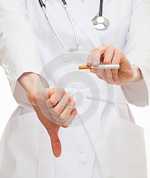 Doctor's hands showing disabling gesture and holding a cigarette