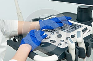 Doctor`s hands on ultrasound device in hospital