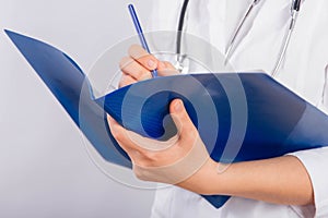 Doctor`s hands in a white coat hold a folder and fill out a medical document close-up isolated on a white background.