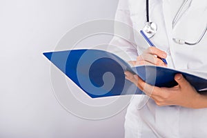 Doctor`s hands in a white coat hold a folder and fill out a medical document close-up isolated on a white background.