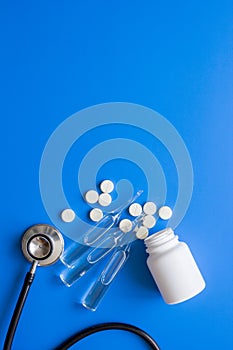 Doctor`s instruments and meds in medical set on blue background space for text