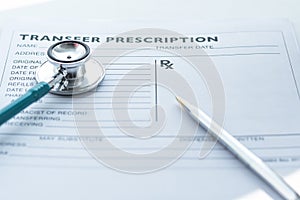Doctor`s notepad work with patient`s medical health record blank paper form for prescription with stethoscope on table