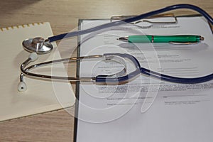 Doctor`s stethoscope on the table. doctor workplace with a stethoscope at table