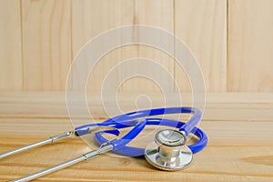 A doctor's stethoscope on wood background