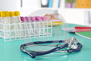 Doctor`s workspace working table with patient`s discharge blank paper form, medical prescription, stethoscope on desk