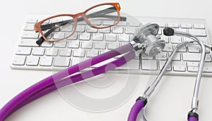 Doctor`s workspace working table with patient`s discharge blank paper form, medical prescription, stethoscope on desk