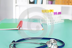 Doctor`s workspace working table with patient`s discharge blank paper form, medical prescription, stethoscope on desk