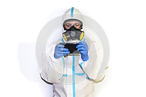 Doctor in safety suit on white background. protection against coronavirus. movil phone photo