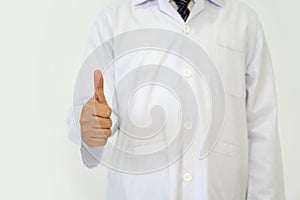 Doctor or scientist in a white lab coat standing with finger thumbs up. Portrait on white background, studio shot