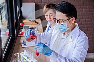 Doctor and scientist working in lap test.