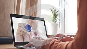 Doctor on the screen of computer and the stethoscope with flag of the EU. European telemedicine