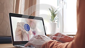 Doctor on the screen of computer and the stethoscope with flag of the EU. European telemedicine