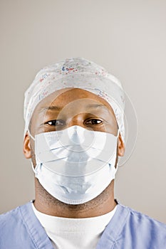 Doctor in scrubs, surgical mask and surgical cap