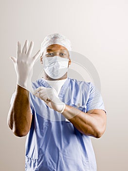 Doctor in scrubs, surgical mask, surgical cap