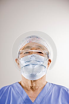 Doctor in scrubs, surgical mask, surgical cap