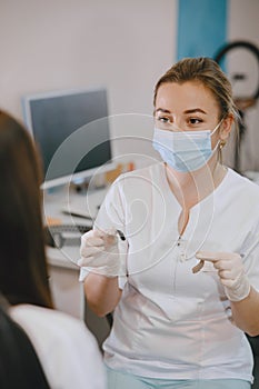 Doctor selects a hearing aid for patient